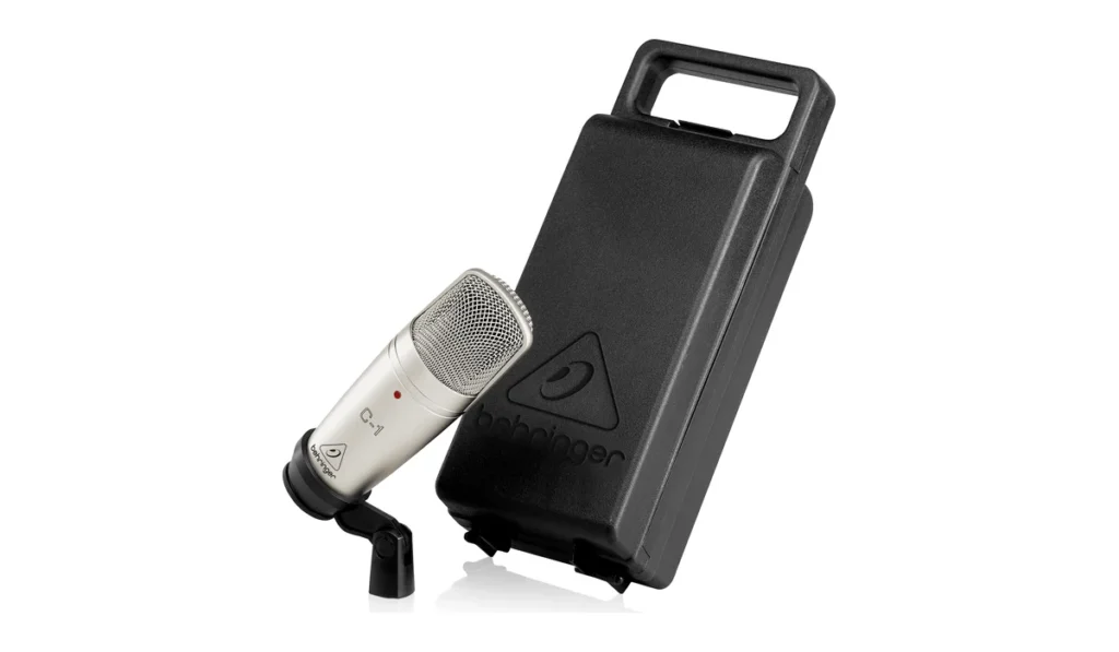 Behringer C-1 studio condenser microphone in silver on its stand adapter, next to its carrying case