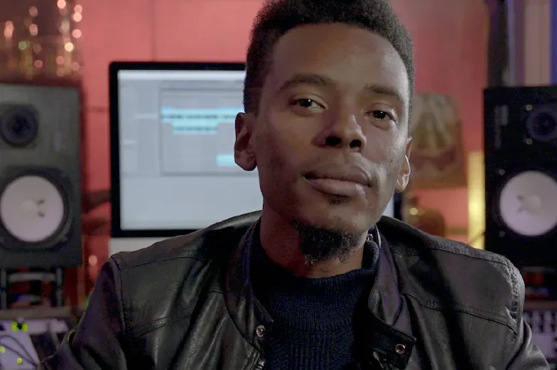 The instructor in a studio with monitors and a screen behind him, from the trailer of Soundfly's The Art of Hip-Hop Production