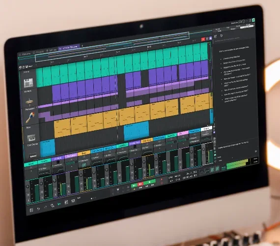 Waveform Free arrangement with green, purple and yellow clips and a mixer on an iMac screen