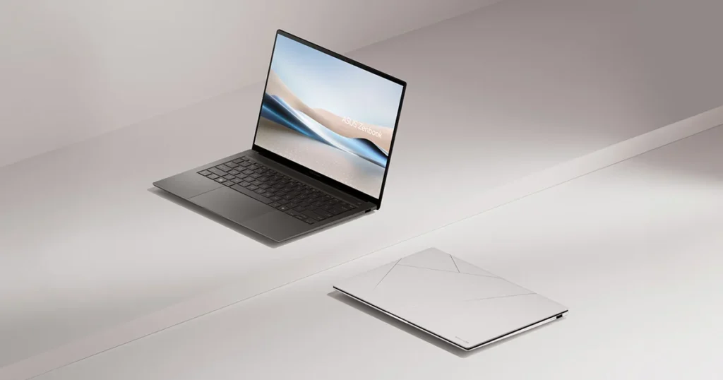 Two ASUS Zenbook S14 laptops, one open and one closed, on a light surface