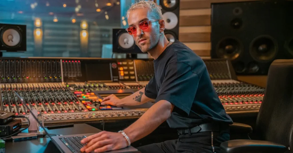 Mix With The Masters image of a producer at a large studio mixing console with big monitor speakers