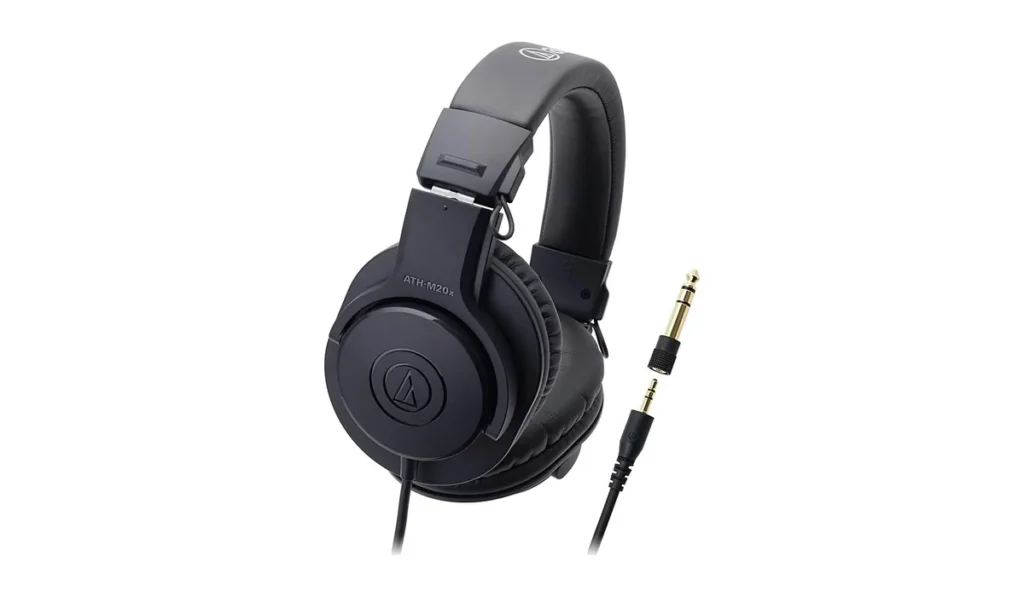 Audio-Technica ATH-M20x closed-back studio monitor headphones with a plug adapter