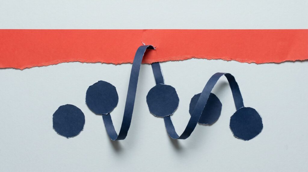 Paper collage of navy dots linked by a paper ribbon that bends up and tears through a red paper strip above them, like a wave rising between samples and breaking through the ceiling
